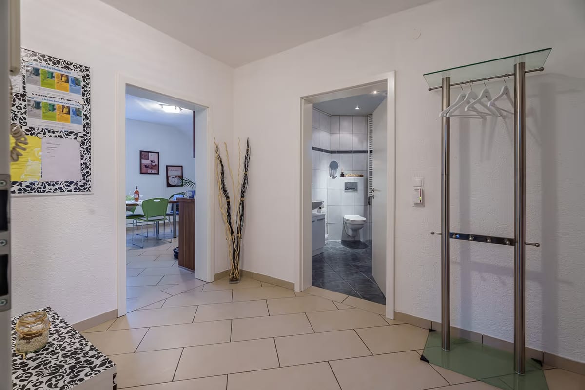 Garderobe im Flur mit Blick zu Bad und Küche
